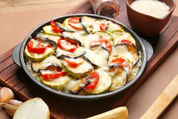 Baking dish with tasty rice casserole on table
