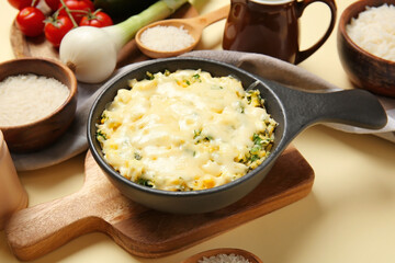 Baking dish with tasty rice casserole on table