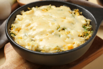 Baking dish with tasty rice casserole on table, closeup