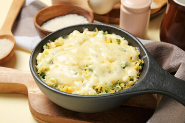 Baking dish with tasty rice casserole on table