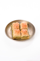world famous baklava making in Gaziantep. Special square slice baklava in metal plate on white background.