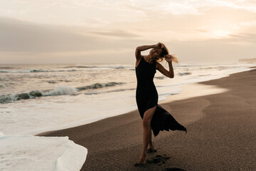 woman on beach is enjoying serene ocean nature during travel holidays vacation outdoors sunset time
