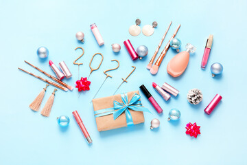 New Year composition with makeup cosmetics on color background