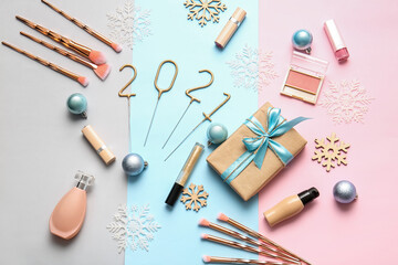 New Year composition with makeup cosmetics on color background