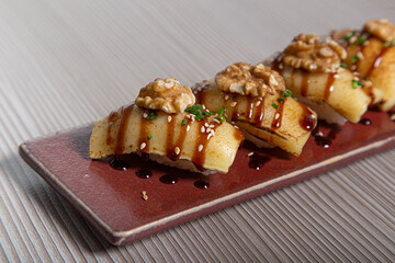 Sushi piece, brie cheese niguiri. closed image
