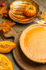 Composition with tasty pumpkin pie on wooden background