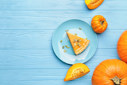 Composition with tasty cut pumpkin pie on wooden background