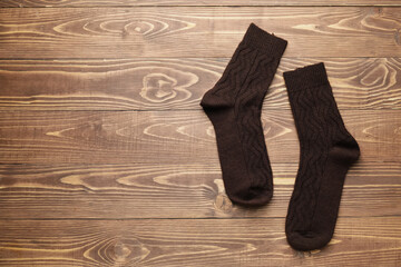 Warm socks on wooden background