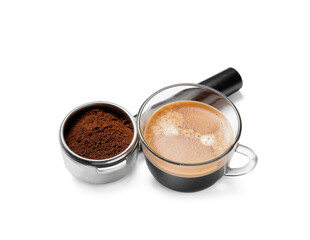Cup of hot espresso and portafilter of coffee machine on white background