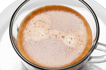 Cup of hot espresso on white background, closeup