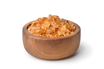 Natural brown  rock sugar made from sugar cane in wooden bowl isolated .on white background.