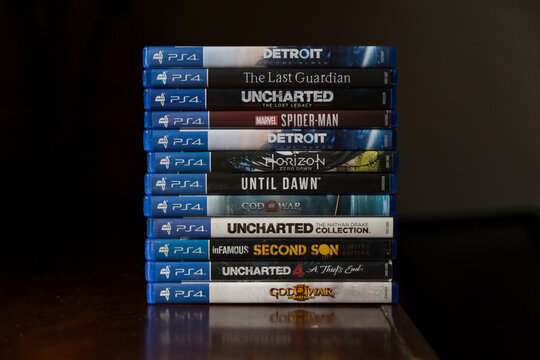 A bunch of Play Station game discs is stacking on top of each other 