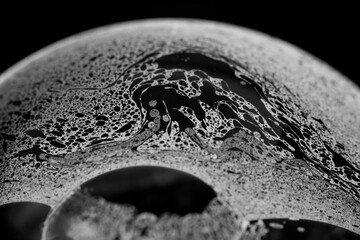 Black and white shot of soap bubble surface. 