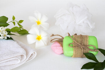 herbal soap spa and terry clothes for health care body skin of lifestyle woman prepare a bath with white flower frangipani on background white
