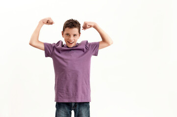 Happy teenaged disabled boy with cerebral palsy smiling at camera and raising clenched fists,...