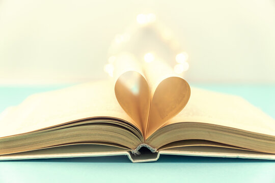 Heart from book pages. vintage style with bokeh in soft light blur background ,copy space, concept for valentine's day.