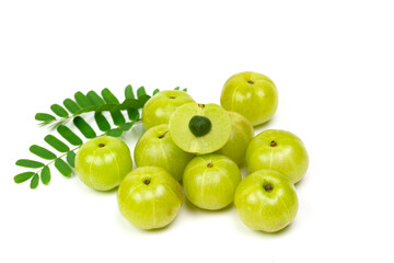Pile of Indian gooseberry fruits or Amla (phyllanthus emblica) with green leaf isolated on white background.