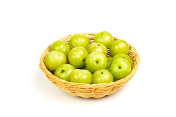 Pile of Indian gooseberry fruits or Amla (phyllanthus emblica) on wicker basket isolated on white background.