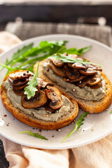 bread with mushrooms and curd cheese, arugula