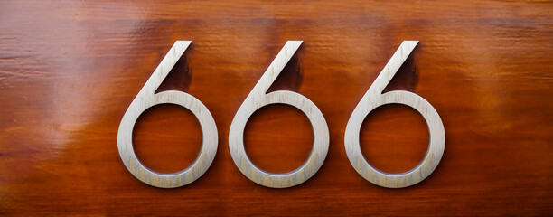 house number six hundred and sixty six (666) embossed in a metal plate. The number of the beast....