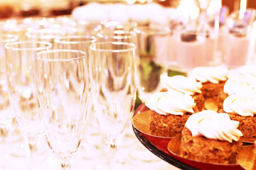Catering table with sliced chocolate cakes decorated with fresh raspberries and nuts.