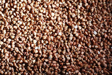 A set of grain cereals. Rice, buckwheat and millet groats in a wooden tray. A grocery set of cereals. Import of grain.