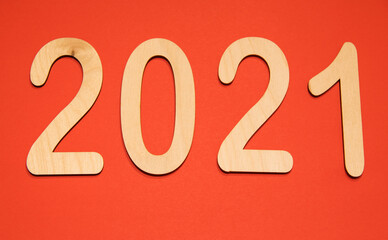 Wooden figures 2021 on red background