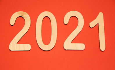 Wooden figures 2021 on red background