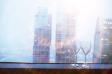 Cocktail glasses on the windowsill by the glass