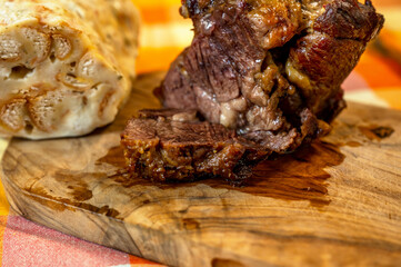 Baked peeled shoulder beef (clod, or fake sirloin) with jelly tendon on kitchen board, dumpling.