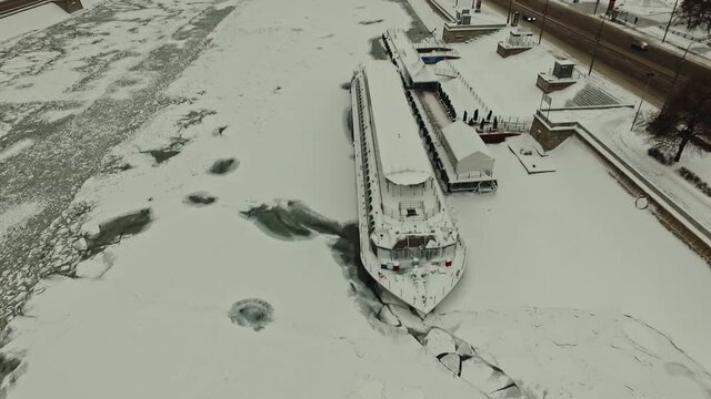 moored, mothballed pleasure ship on the embankment of the frozen Moskva River