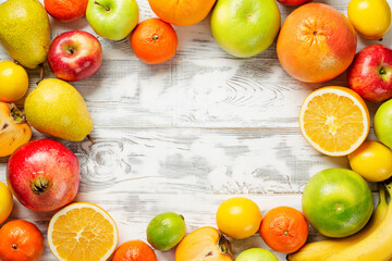 Fresh fruits background. Food photography different fruits on wooden white background.Flat lay.
