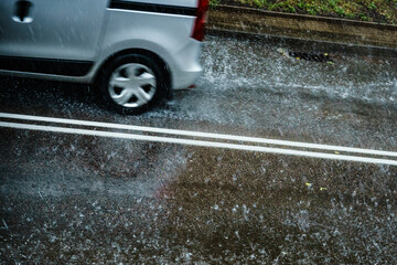 Rainy road with car