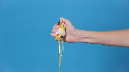 Slow motion shooting of smashed egg in woman's hand - Powered by Adobe