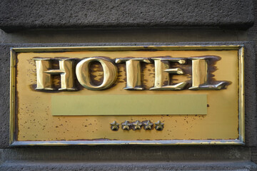 golden Board or signboard for a 5 five star hotel. 5 star hotel signage board. Wall of a building...