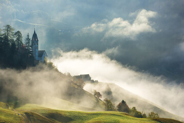 Landscape of beautiful village with church in Dolomites mountains