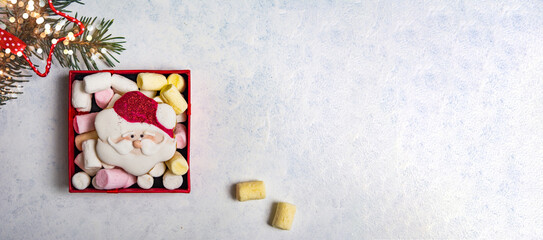 Christmas cookies and marshmallow on a table with winter holidays festive decorations