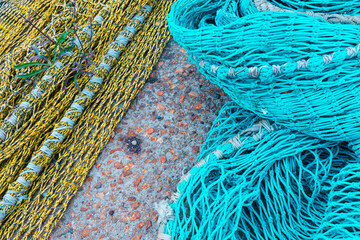 blue and green fishing net on concrete