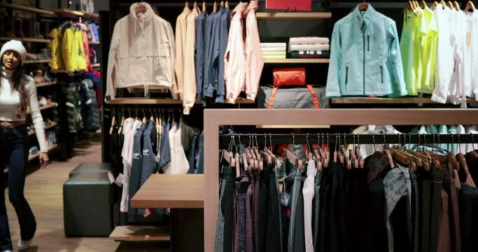 Couple goes shopping during winter vacation. We can see winter clothes, perfect to go skiing in the mountains 4K - Powered by Adobe