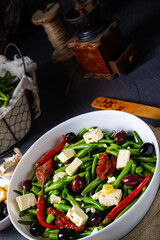 Spicy green bean salad with olives, feta cheese and dried tomatoes