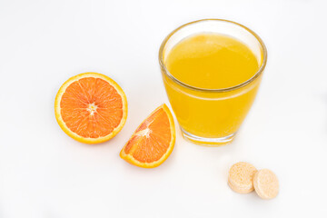 Orange flavored vitamin c effervescent tablet dissolve in glass of water