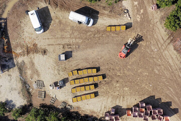 Orange picking loading station with Red Forklift moving a loaded pallet, Aerial view.