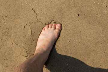Wet foot on the sand , Ios Island, Greece.
