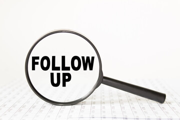 words FOLLOW UP in a magnifying glass on a white background. business concept