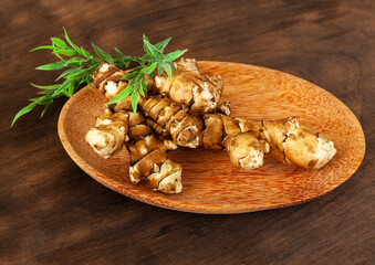 jerusalem artichoke on brown background. Topinambur isolat