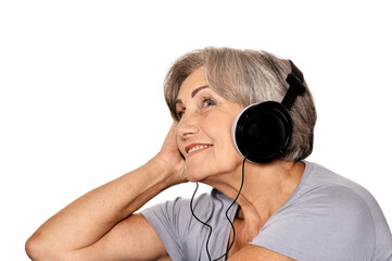 Close-up portrait of senior woman listen music in headphones