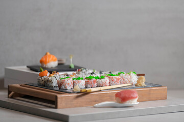 freshly made uramaki and chopsticks on a tray. sushi and healthy food concept.