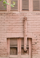 Painted window shutter and chimney and brick wall of an old house, Tehran, Iran