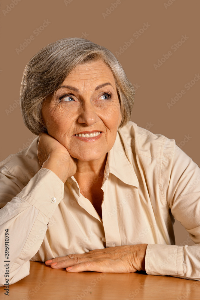 Sticker Portrait of happy senior woman at table