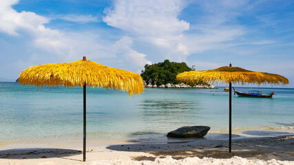 Straw beach umbrella with beautiful seascape background